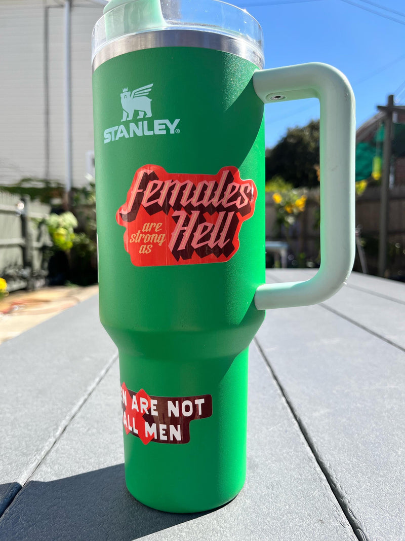 Badass sticker collection on a green stanley